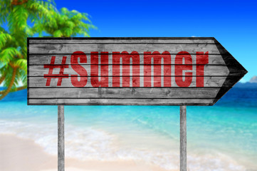 Red The word with hashtag SUMMER wooden sign with on a beach bac