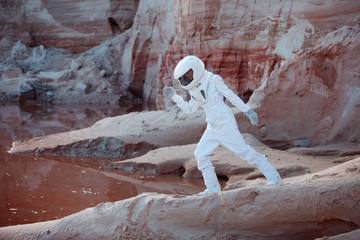 Wall Mural - Water on Mars, futuristic astronaut, image with the effect of