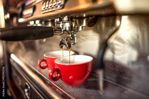 Fotografie, Obraz coffee machine preparing fresh coffee and pouring into red cups at restaurant, bar or pub