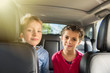 © jackfrog - Two ten years old are sitting at the back of a car