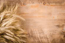 Ears Of Wheat On Wooden Background. Frame