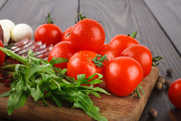 Wall Mural - Cherry tomatoes, rucola, salami on a cutting board