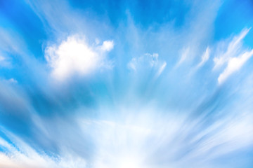Wall Mural - sun rays shining through blue clouds