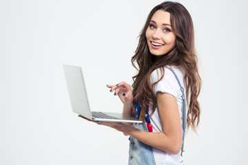 Wall Mural - Portrait of a smiling girl holding laptop computer
