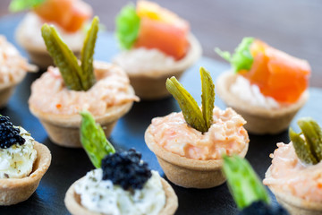 Wall Mural - Multiple mini pastry tartlets with seafood filling.