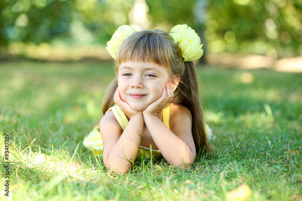 Little girl on grass outside closeup