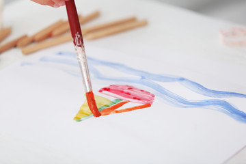 Wall Mural - Cute little boy painting picture, close-up