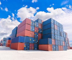 group of numerous shipping containers in port  with blue sky