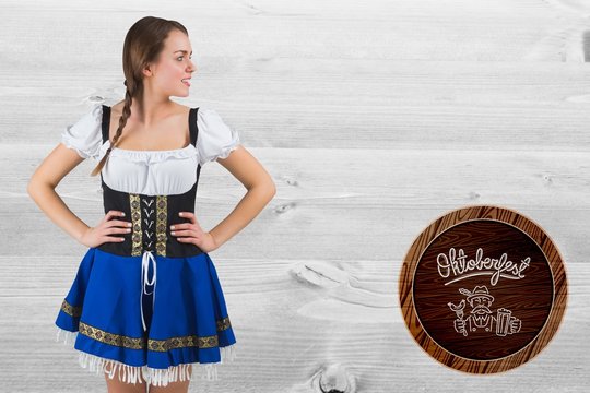 Composite image of pretty oktoberfest girl with hands on hips