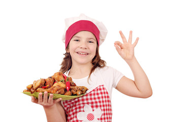 Wall Mural - happy little girl with chicken drumstick and ok hand sign