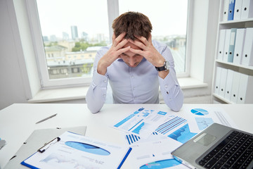 Wall Mural - stressed businessman with papers in office