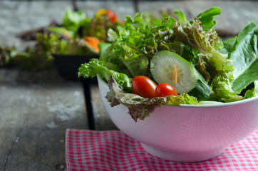 Vegetable salad preparation on wooden board background