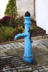 Ancient blue hand water pump