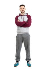 Wall Mural - Young happy bearded casual man in sportswear with crossed hands isolated 