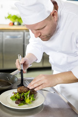 Wall Mural - Professional chef prepare meat dish at restaurant