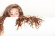 © Voyagerix - Little girl kid with long hair holds empty banner.