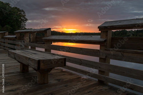 Fotografie, Obraz View of empty bench with sunset in the background