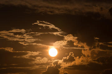 Wall Mural - orange sky with sun and black clouds