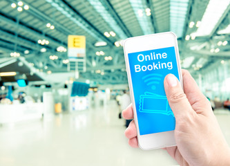 Poster - Hand holding mobile with online booking with blur airport backgr