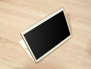 Poster - White tablet on the wooden table