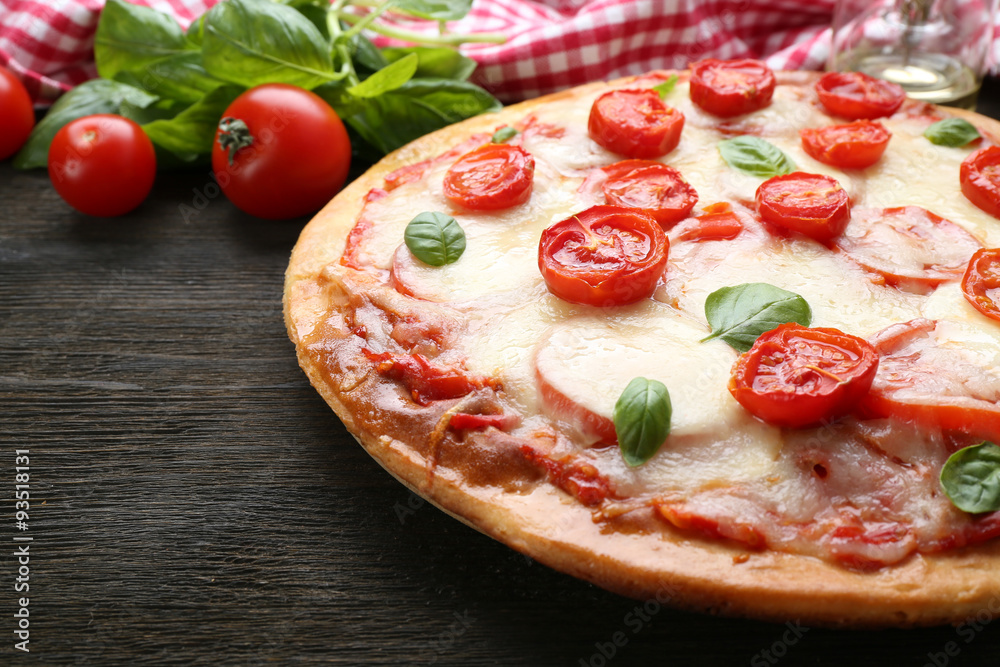 Delicious pizza with cheese and cherry tomatoes on wooden table, closeup