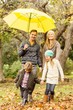 © WavebreakMediaMicro - Smiling young family under umbrella