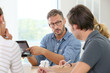 © goodluz - Teacher with group of students working on digital tablet
