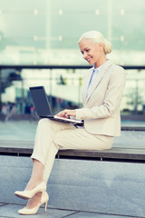 Sticker - smiling businesswoman working with laptop outdoors