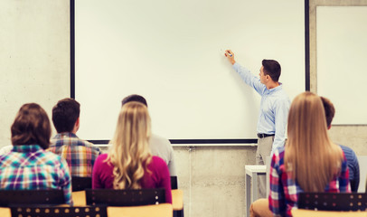 Wall Mural - group of students and smiling teacher in classroom