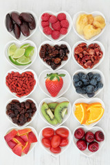 Wall Mural - Mixed Fruit Selection. Fresh mixed fruit background selection with fruits high in antioxidants, vitamin c and dietary fibre in heart shaped dishes.