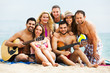 © JackF - Adults with guitar at beach