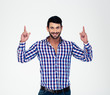 © Drobot Dean - Happy man pointing fingers up at copyspace
