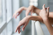 © master1305 - The  hands of two classic ballet dancers at barre