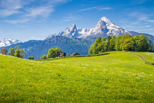 Idyllic Landscape In The Alps With Green Meadows And Farmhouse