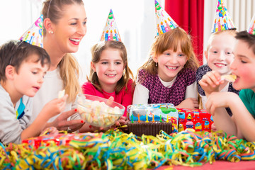 Wall Mural - Children on birthday party nibbling candies