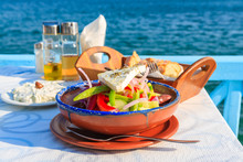 Greek Salad On Table In Greek Tavern With Blue Sea Water In Background, Samos Island, Greece