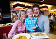 © .shock - family having lunch in shopping mall