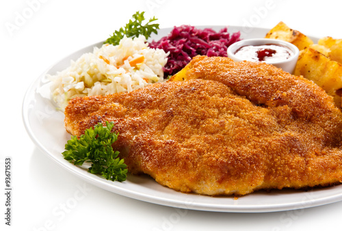 Fototapeta do kuchni Fried pork chop, baked potatoes and vegetable salad 