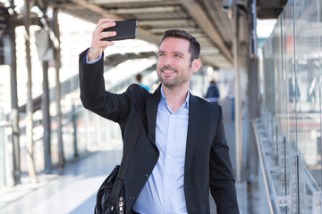 Wall Mural - Young attractive businessman taking some selfies