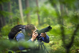 Fototapeta Zwierzęta - Man photographing in the forest