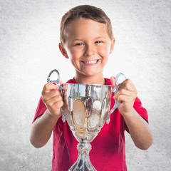 Kid holding a trophy