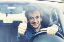 Young Man Thumbs Up Gesture In Car
