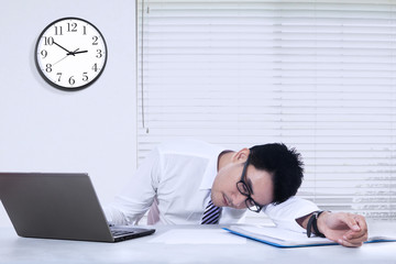 Businessperson sleeping in the office