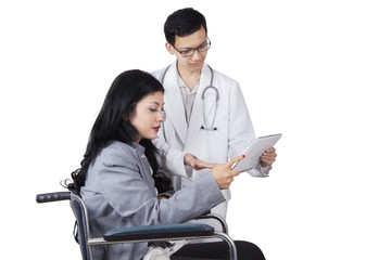 Wall Mural - Physician and disabled woman holding tablet