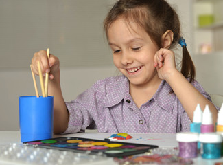 Wall Mural - cute little girl drawing at home