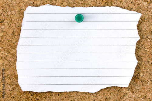Fotografie, Obraz Ripped blank white striped sheet on cork board with green small thumb tack