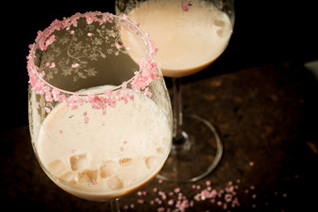 Wall Mural - Irish cream liqueur in a glass with ice with a pink sugar