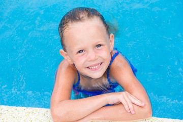 closeup little beautiful girl in outdoor swimming pool