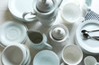 © Africa Studio - Set of white ceramics dishes on wooden table, closeup