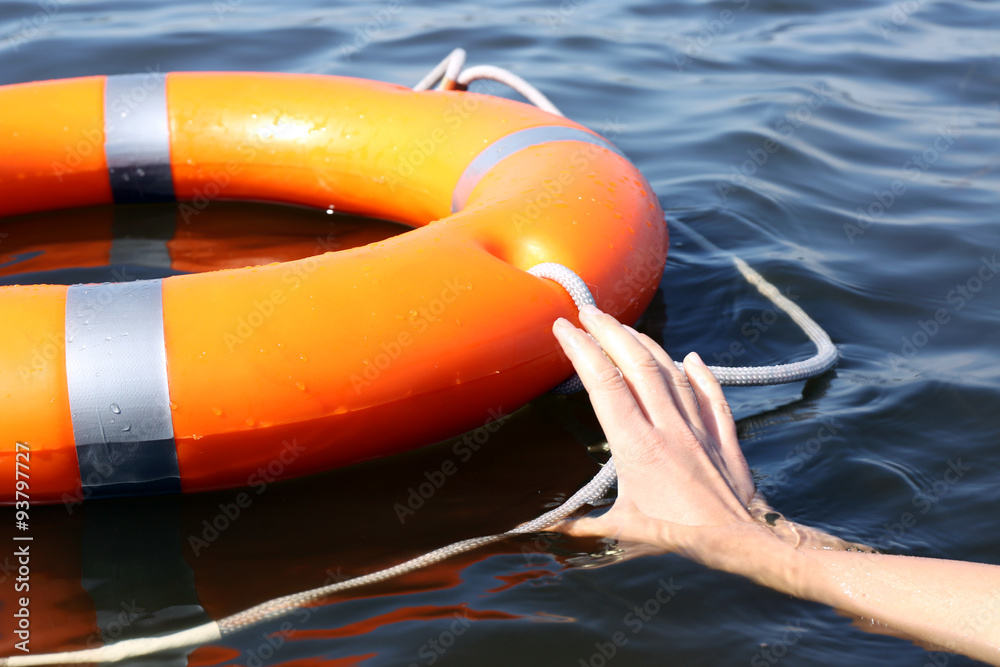 Hand trying to hold life buoy